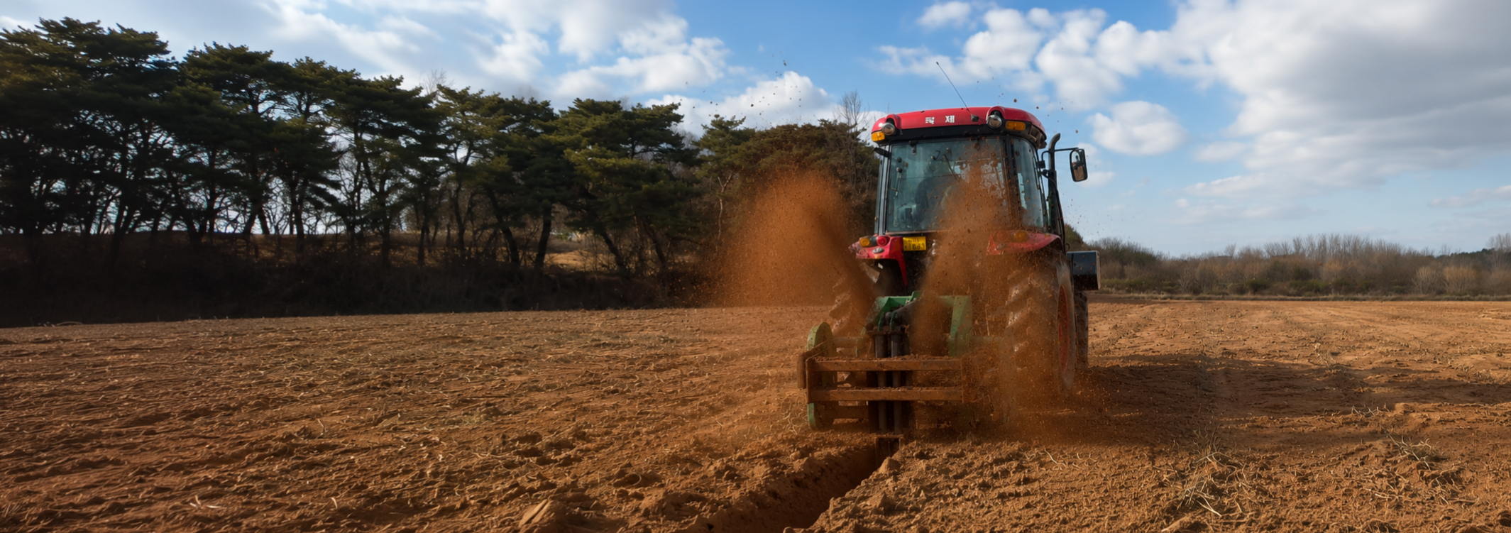 WeCan WRD rotary ditcher cutting drainage furrows at sunset